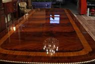 Burnished razor thin lacquer finish captures light and makes this a stately dining table