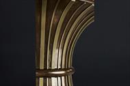 modern brass stringing on dark transitional pedestal