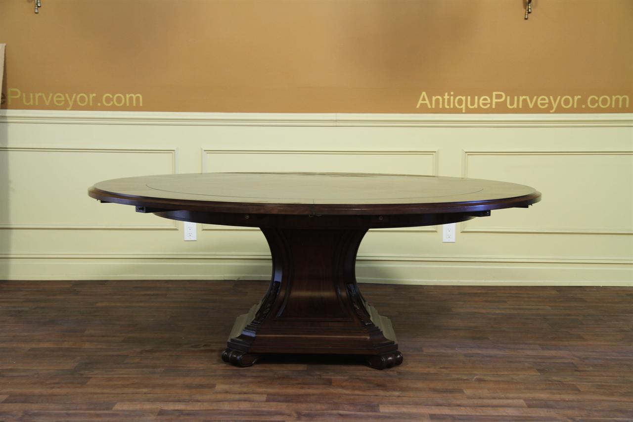 Expandable perimeter leaf table with geometric marquetry and solid base.