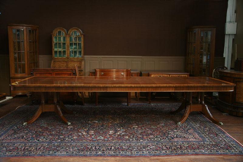 Henredon dining table with leaves, on traditional birdcage pedestals.