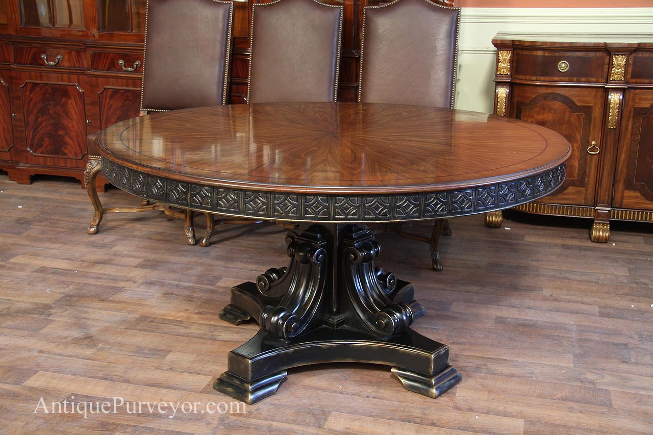 Spanish style table with heavily carved base and black and gold accents.