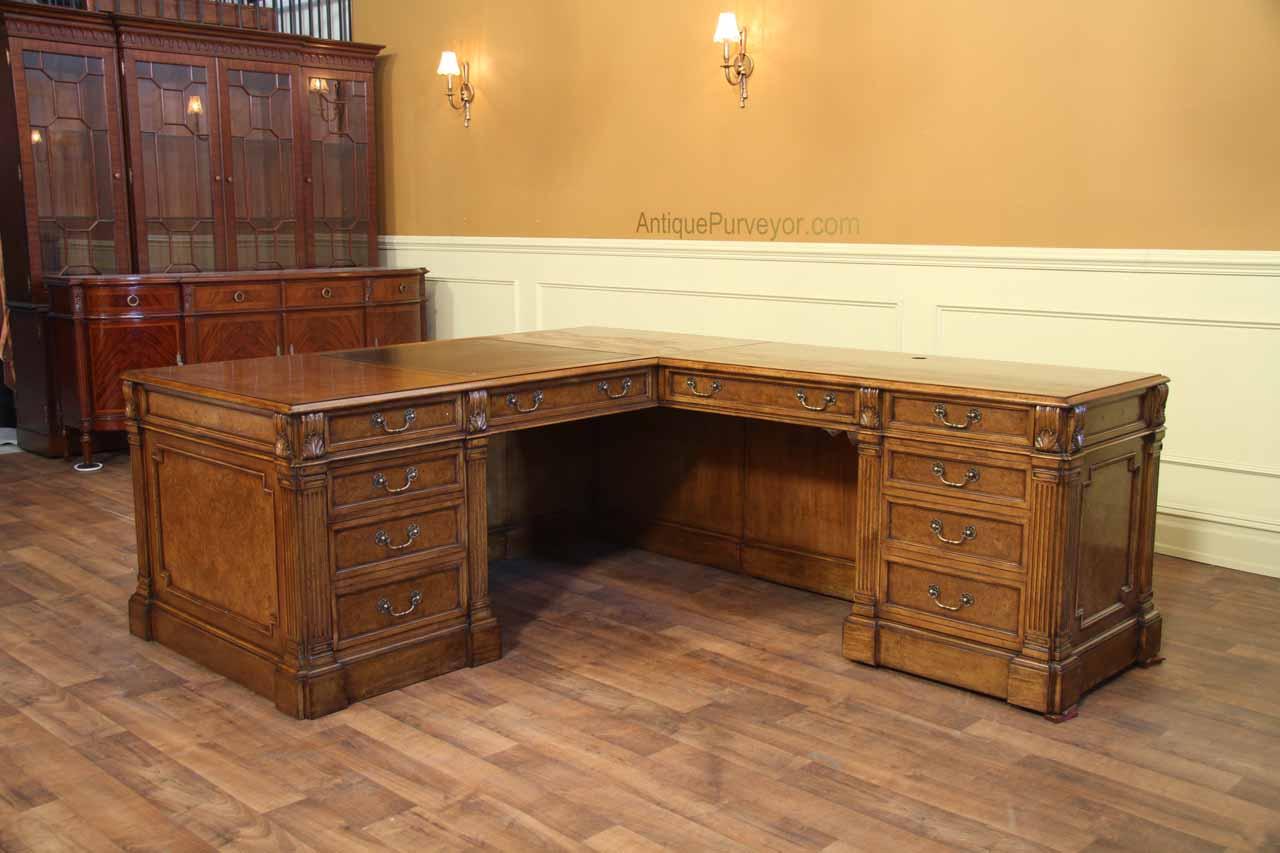 Traditional walnut L shape desk with leather top.