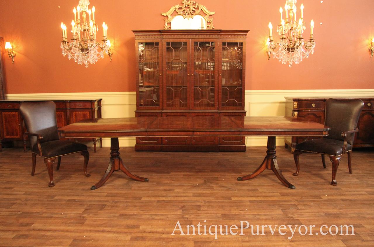 Walnut table opened to 10 feet and shown with leather chairs