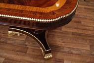 American Empire or Regency style scallop corner dining table with gold leaf accents