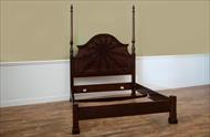 Queen size poster bed with dark wood finish