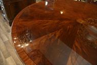 Adams style pinwheel inlay details on round mahogany dining table