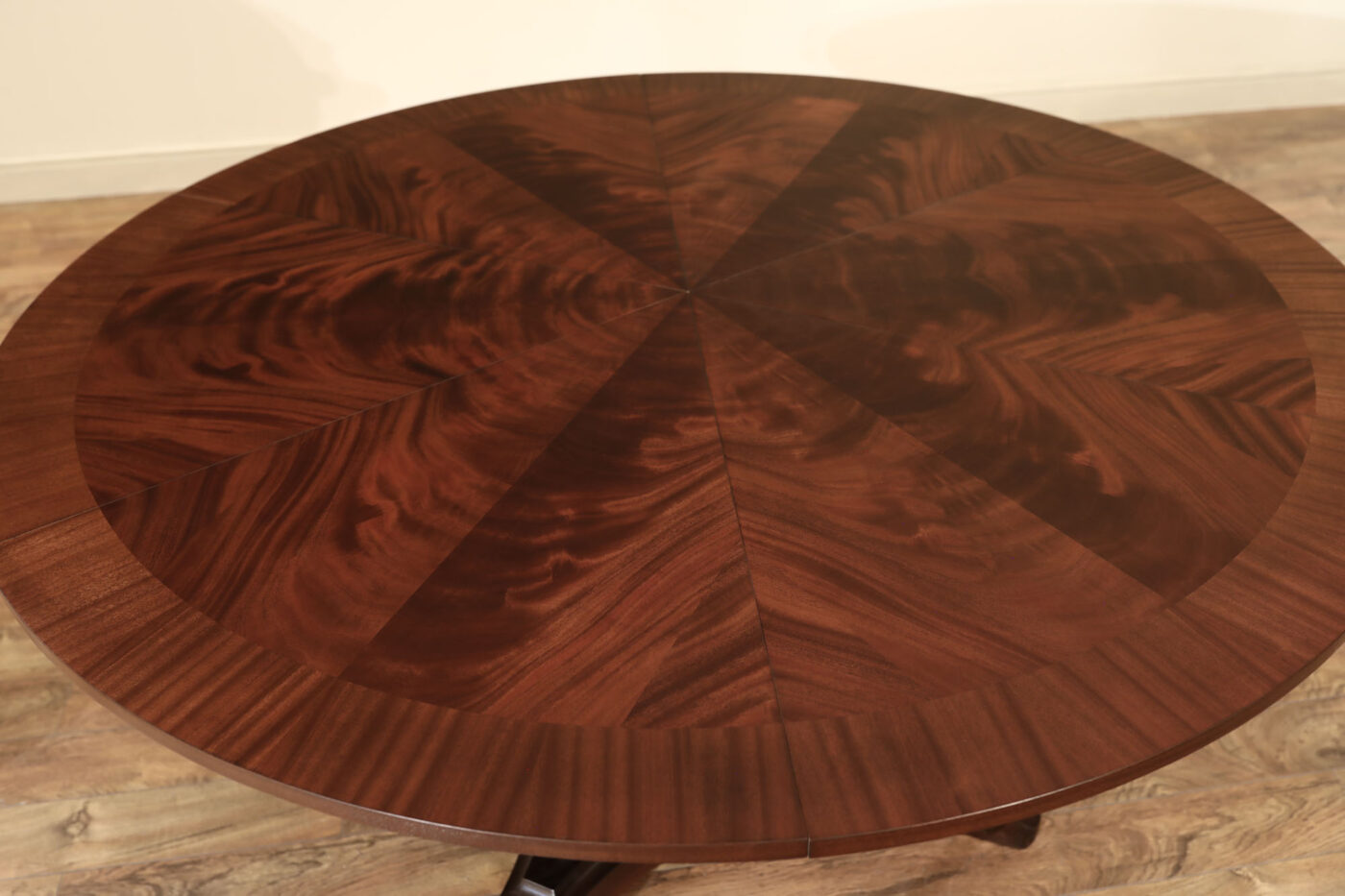 Mahogany Jupe table.  64 inch round to round solid dining table with brown mahogany finish. Leaves are self storing and fold out to make a larger 84 inch round dining table. - Image 10