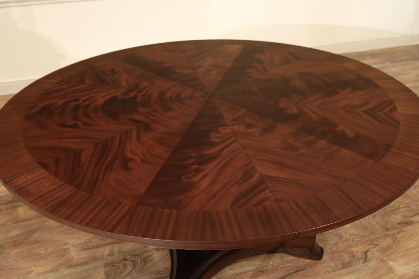 Mahogany Jupe table.  64 inch round to round solid dining table with brown mahogany finish. Leaves are self storing and fold out to make a larger 84 inch round dining table. - Image 12