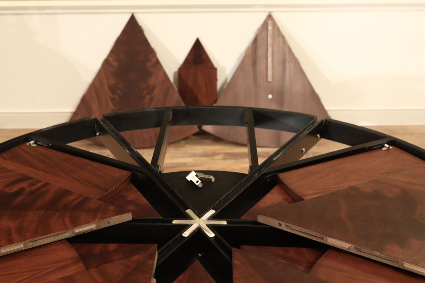 Mahogany Jupe table.  64 inch round to round solid dining table with brown mahogany finish. Leaves are self storing and fold out to make a larger 84 inch round dining table. - Image 9