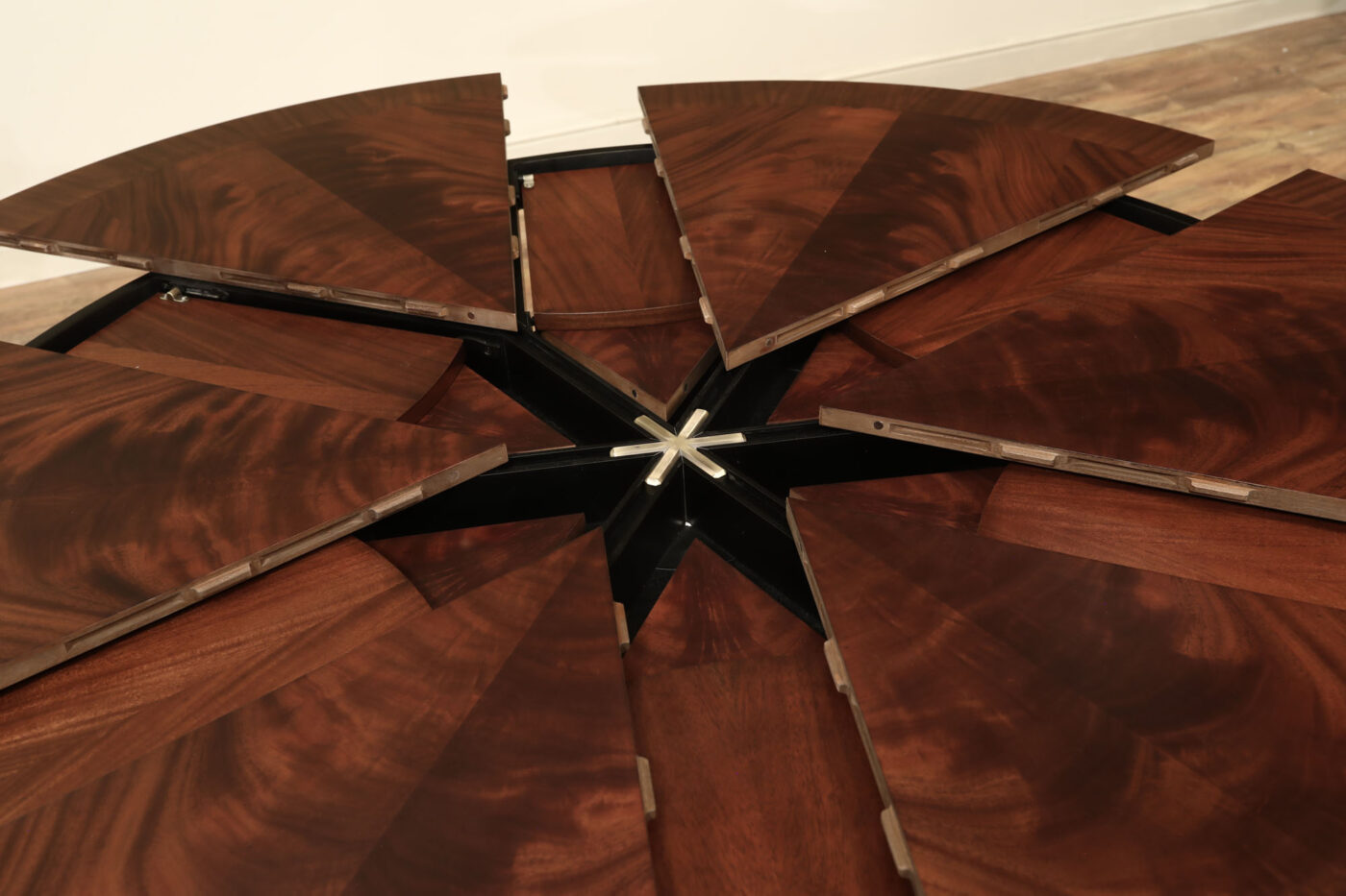 Mahogany Jupe table.  64 inch round to round solid dining table with brown mahogany finish. Leaves are self storing and fold out to make a larger 84 inch round dining table. - Image 8