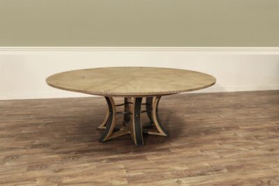 Transitional gray oak jupe table with hammered iron pedestal base.  64 Inch round expandable dining table can be opened to 84 inches round