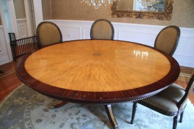 Custom American made 84 inch round satinwood and mahogany inlaid dining table