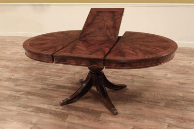 Exclusive 48" round to oval mahogany breakfast table with self-storing leaf. an AP Exclusive by AntiquePurveyor
