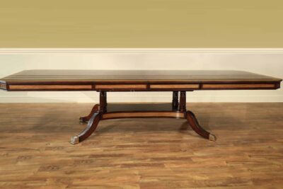 Extra large and wide mahogany dining table with self storing leaves and extra sturdy platform base.