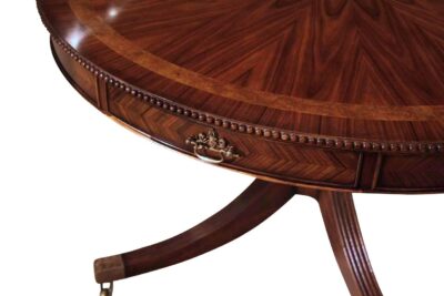 Formal rosewood and mahogany dining or center table with drawers. Finely carved beaded edge.