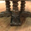 Round rustic dining table with walnut finish and robust base. - Image 5
