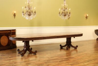 Rare and unique burly ash oval dining table with two rope and tassel carved pedestals.  Wide and large oval dining table