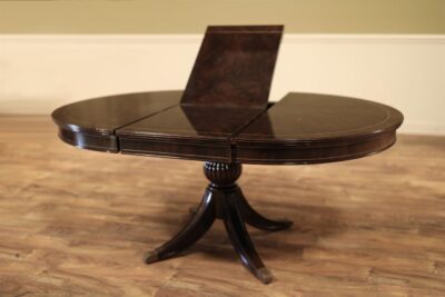 Round to Oval Dining Table in Dark Walnut Finish, With Self-Storing Leaf. Part of the Ap Exclusives Collection an AP Exclusive by AntiquePurveyor