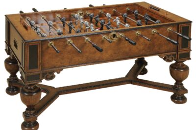 Walnut foosball game table by Maitland Smith Furniture. It has lion and monkey players.