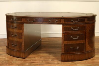 Oval gold tooled leather top walnut partners desk with file hangers. Burl walnut top and brass hardware. A high end traditional desk. 8108-53